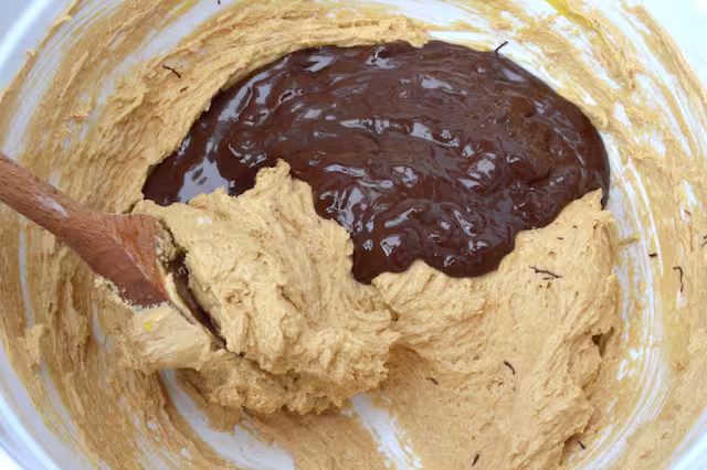 Melted chocolate added to bowl.