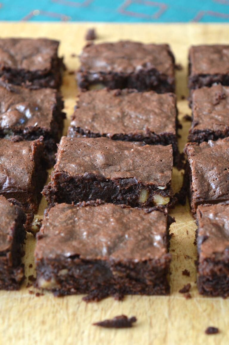 Homemade chocolate fudge brownies on wooden board.