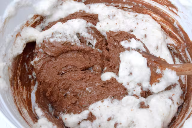 Folding egg whites into chocolate mixture.