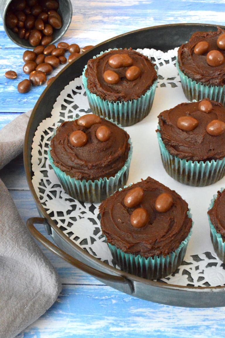 Chocolate and peanut butter cupcakes on a doily lined tray.
