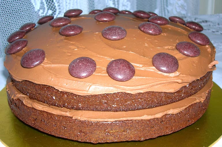 A chocolate orange cake sandwiched and topped with chocolate buttercream and decorated with minstrels.
