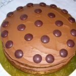 Chocolate orange cake decorated with Minstrels and chocolate frosting.