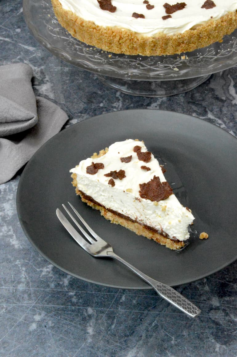 Slice of lime cheesecake with surprise chocolate layer.