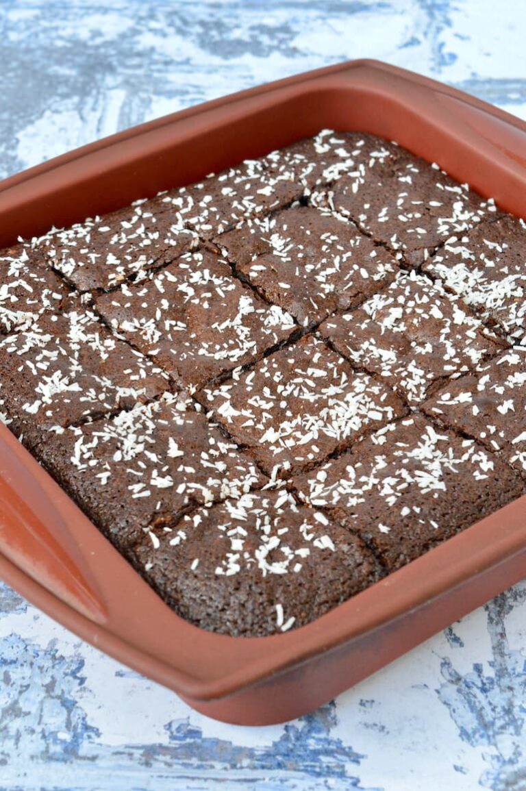Pan of homemade fudgy coconut brownies cut into squares.