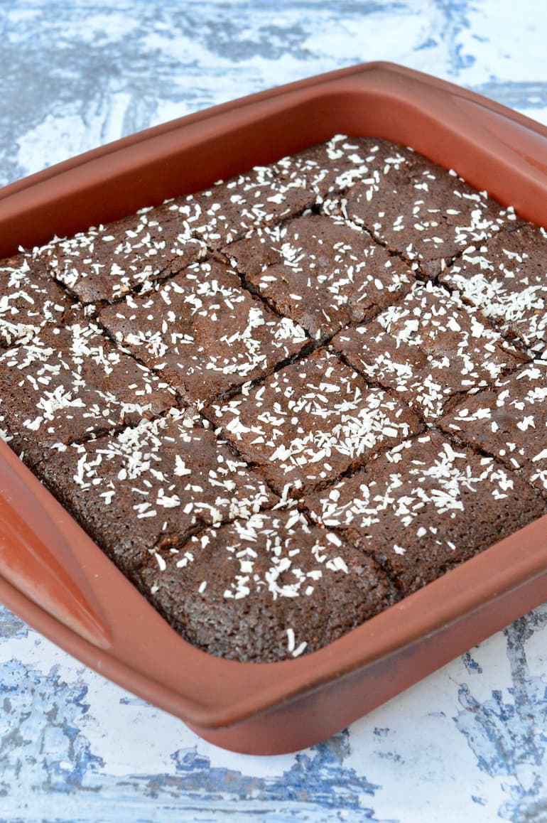 Pan of homemade fudgy coconut brownies cut into squares.