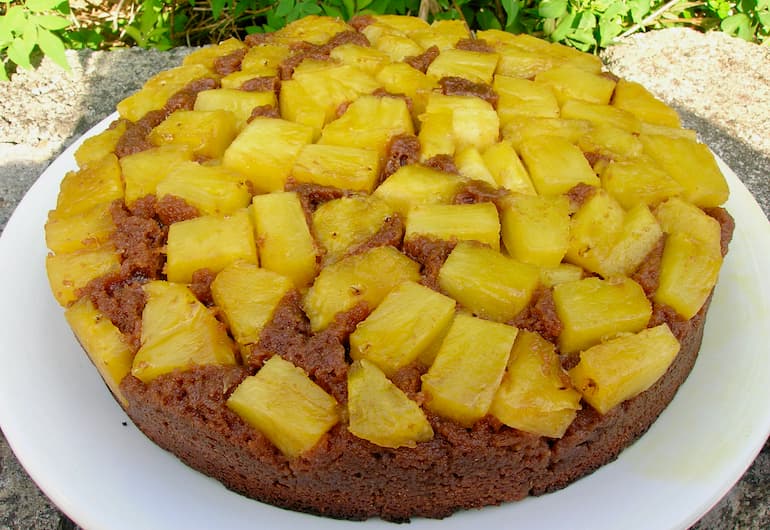 Homemade chocolate pineapple upside down cake on a white plate.