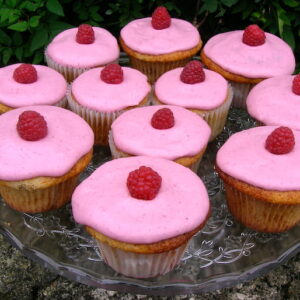 A plate of raspberry and white chocolate cupcakes.