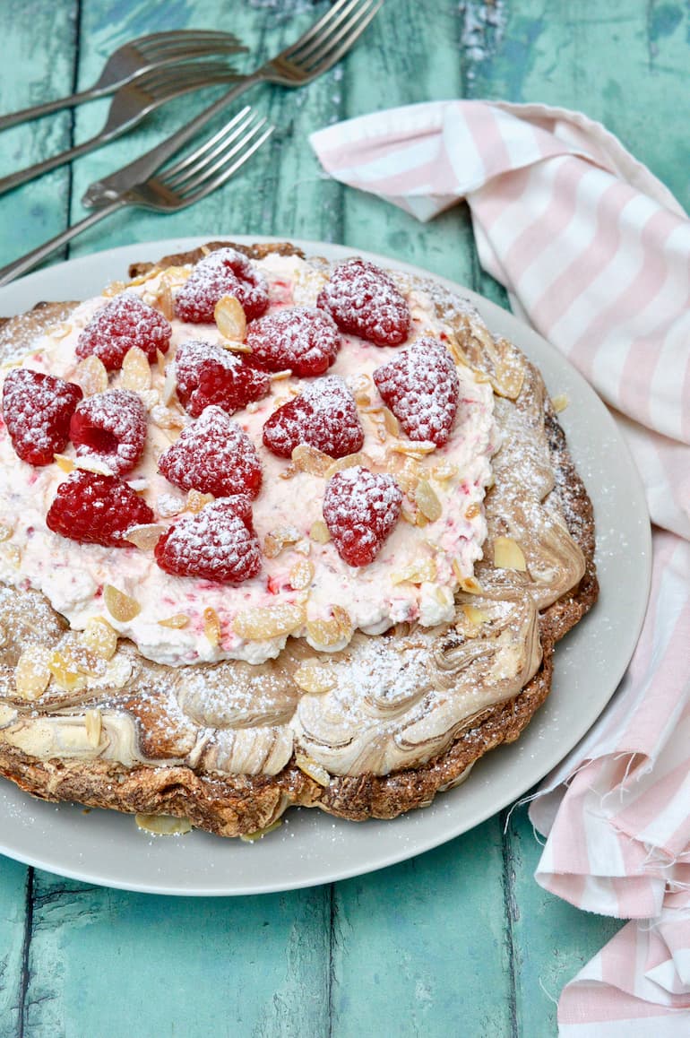 Large marbled chocolate meringue with raspberries and cream.