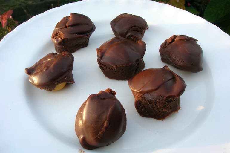 Milk chocolate lemon balm truffles with ground cherries.