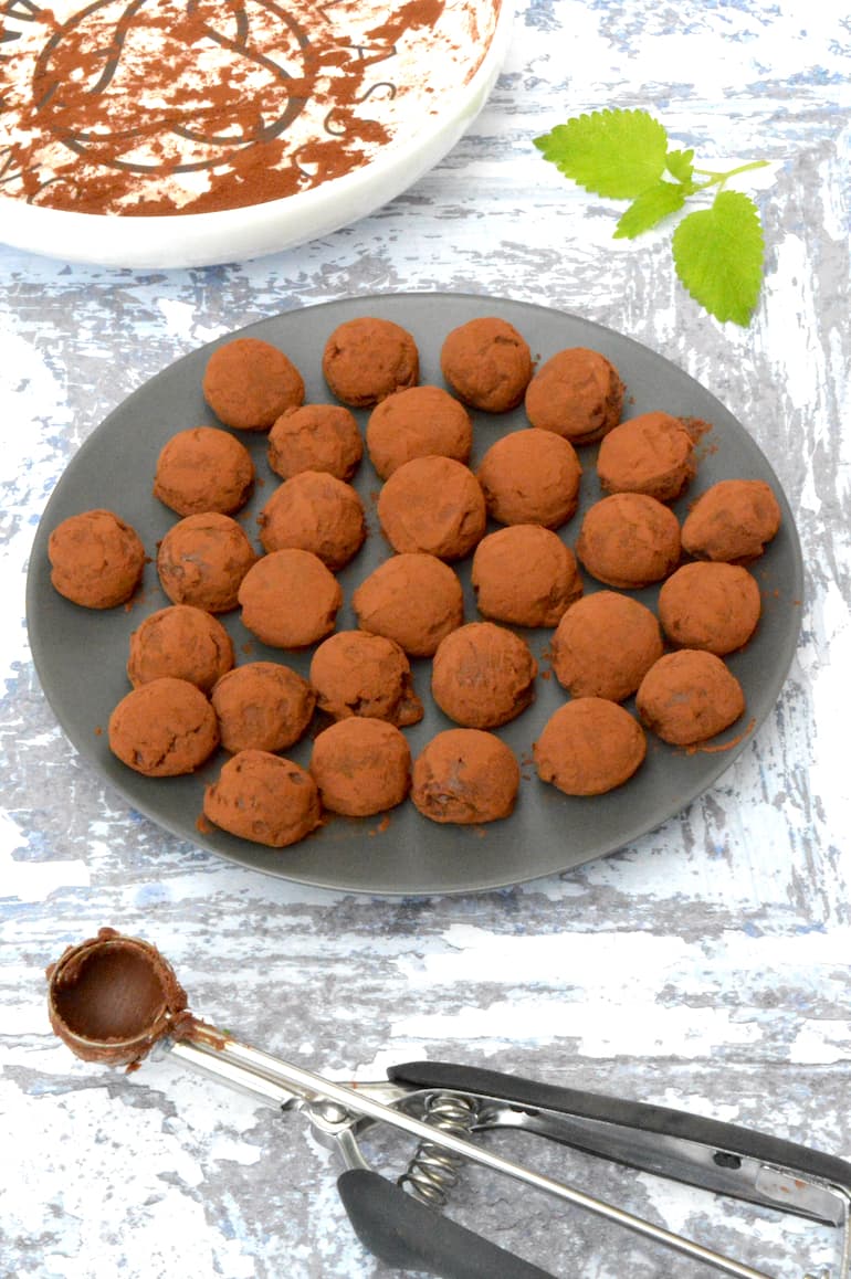 A plate full of lemon balm chocolate truffles.
