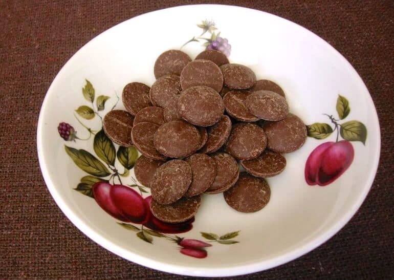A saucer of milk chocolate baking buttons. 