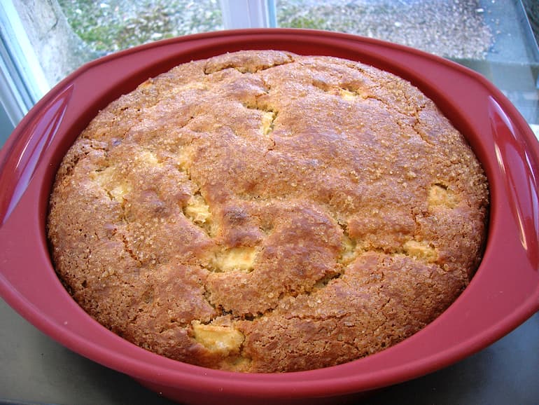Triple apple cake flavoured with orange in pan.