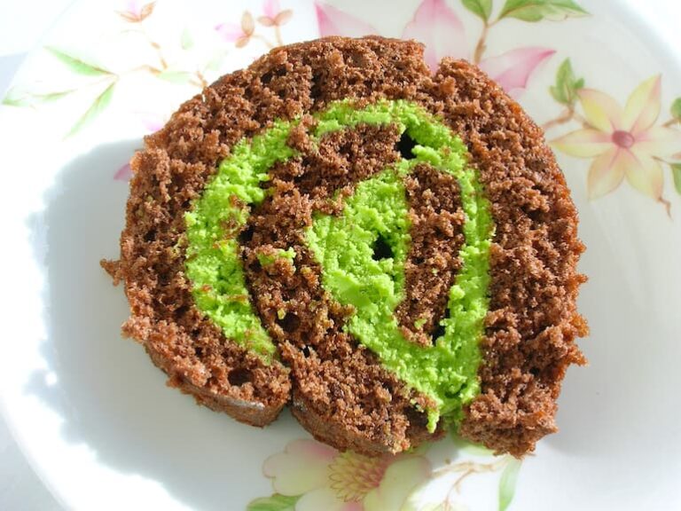 A slice of matcha chocolate roll on a plate.