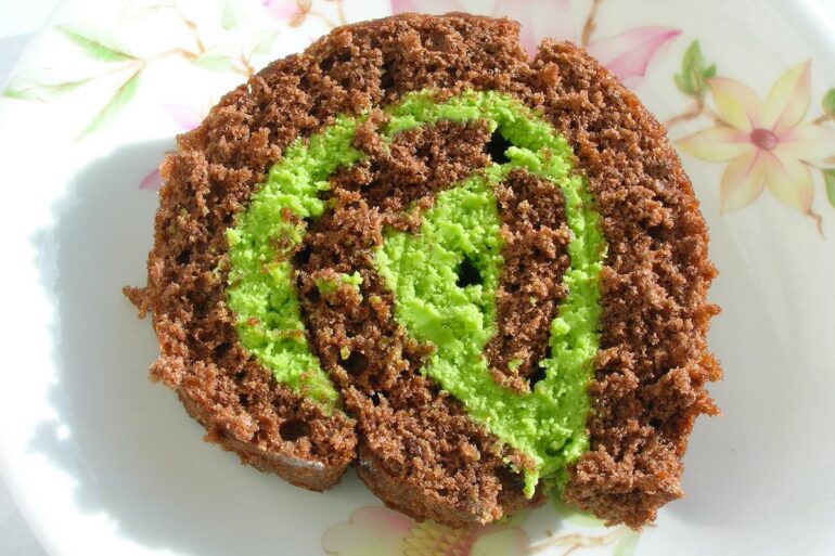 A slice of matcha chocolate roll on a plate.