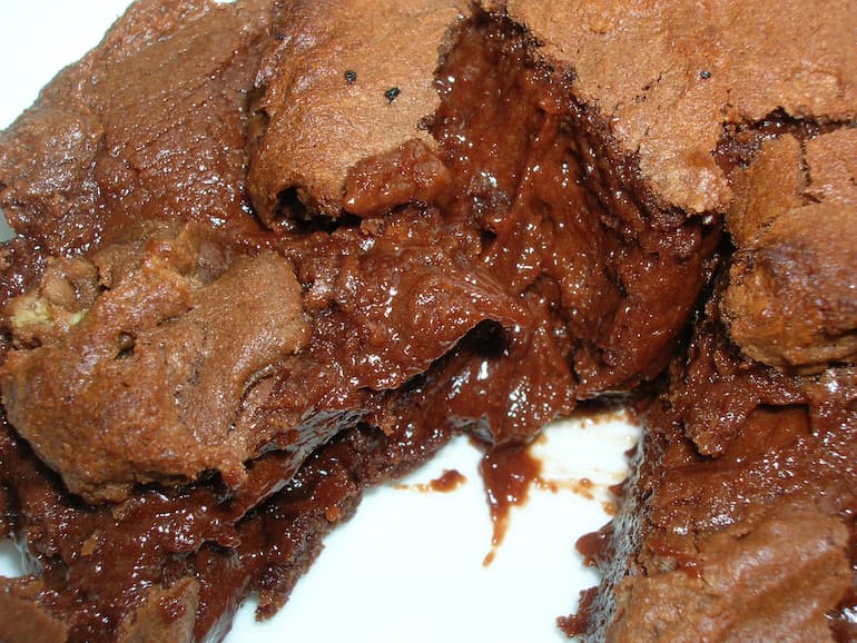 Molten lava spilling out of bitter chocolate puddings.