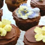 Amaretto chocolate Easter cupcakes decorated with chocolate buttercream and crystallised spring flowers.