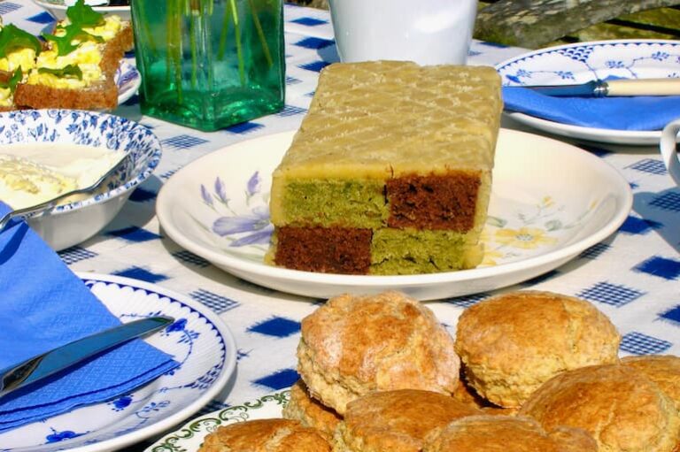 Chocolate matcha Battenberg cake on tea table with scones.