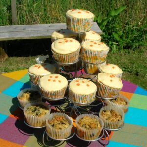 Apricot curd and white chocolate cupcakes in wire cupcake stand.