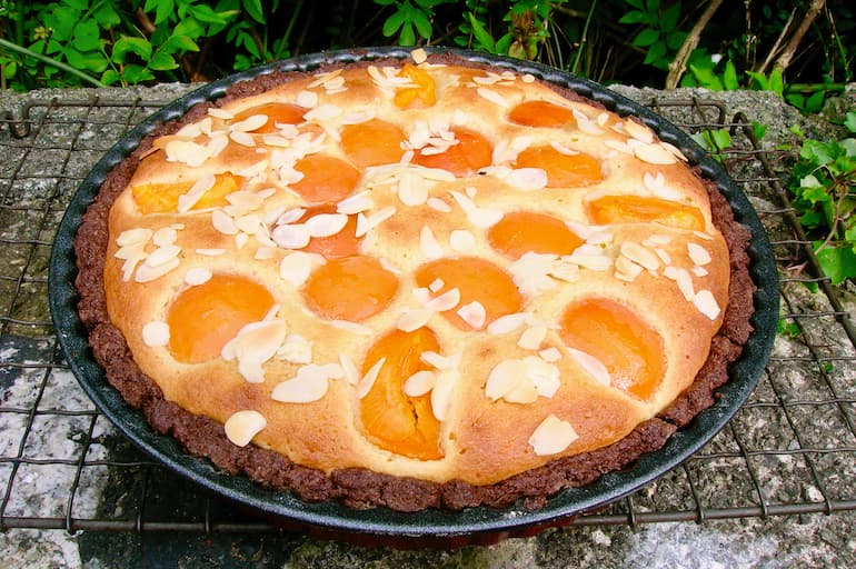 Homemade apricot frangipane tart in tin.