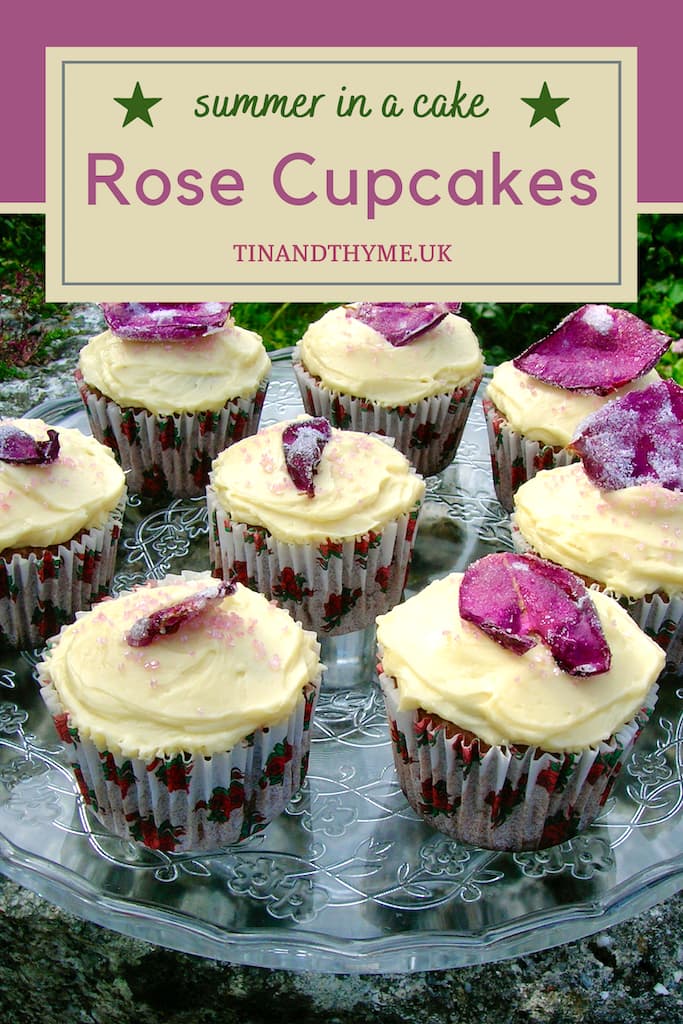 Chocolate rose cupcakes complete with buttercream and crystallised roses on a glass cake stand. Text box reads "summer in a cake rose cupcakes".
