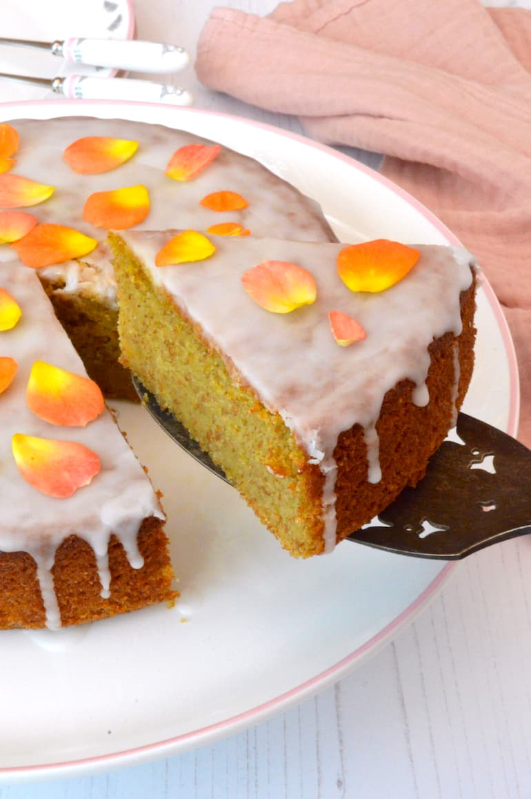 A slice of golden beetroot cake covered in light orange glaze.