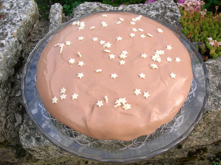 A golden beetroot cake covered in light chocolate icing.