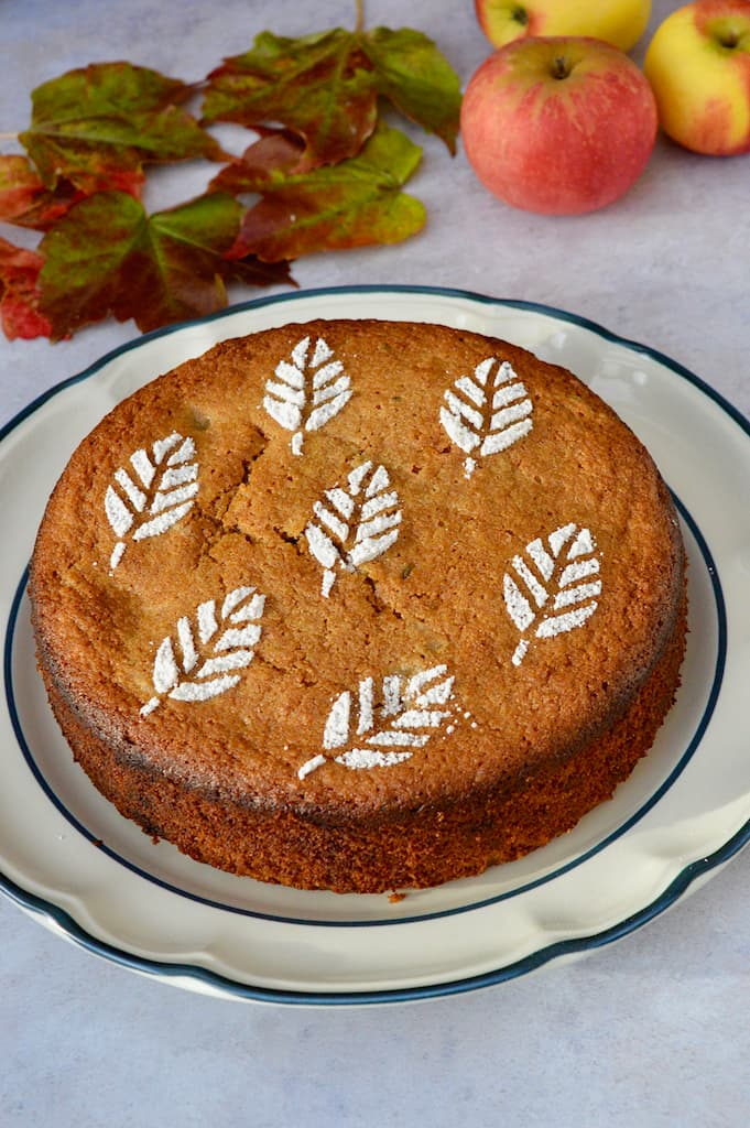 A round apple and thyme cake sitting on a plate.