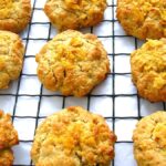 Crunchy cornflake biscuits cooling on a wire rack.
