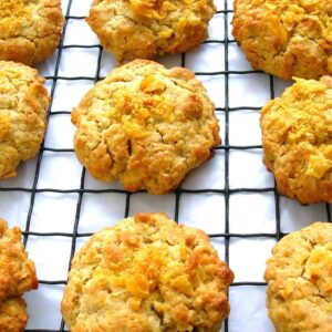 Crunchy cornflake biscuits cooling on a wire rack.