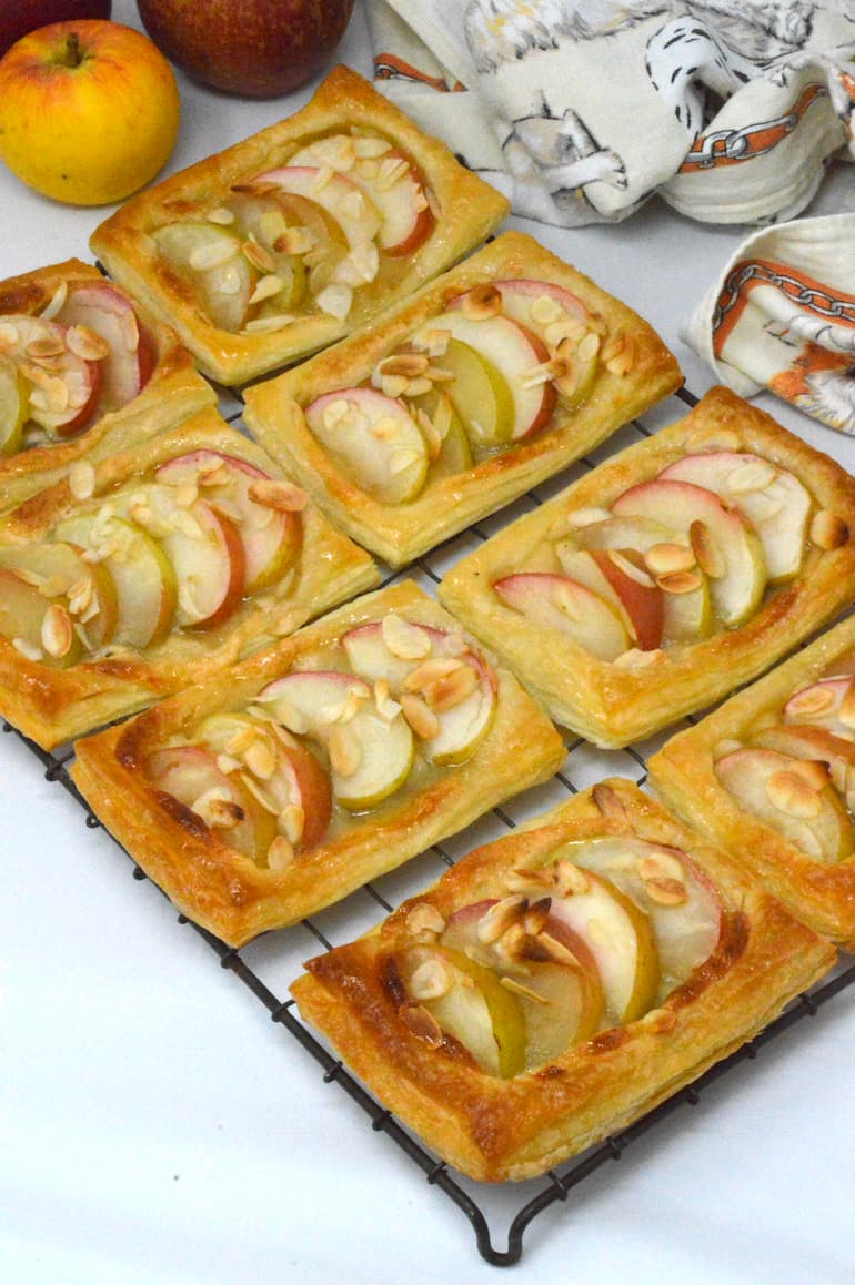 Apple and almond pastries cooling on a wire rack.
