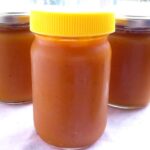Three jars of homemade pumpkin butter.