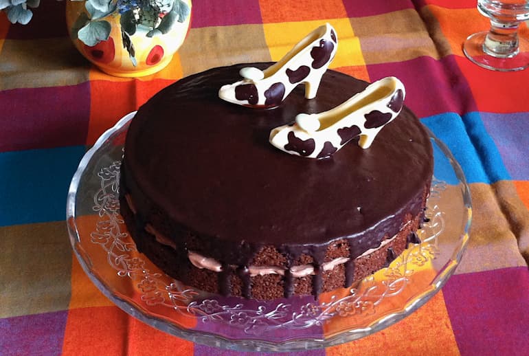 Triple chocolate orange cake with white chocolate shoes.