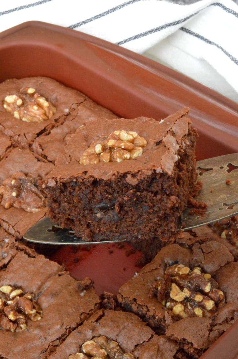 Black bean brownies in tin with one on cake slice.