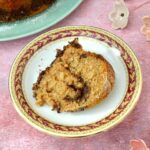 Bundt slice of homemade chocolate pecan streusel cake on plate.