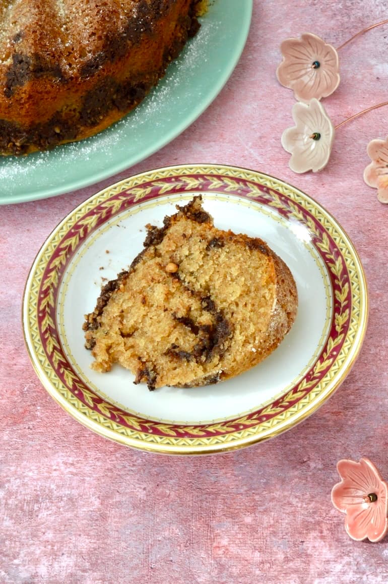 Bundt slice of homemade chocolate pecan streusel cake on plate.