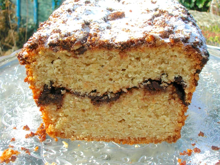 A pecan chocolate streusel loaf cake with a slice or two already taken.