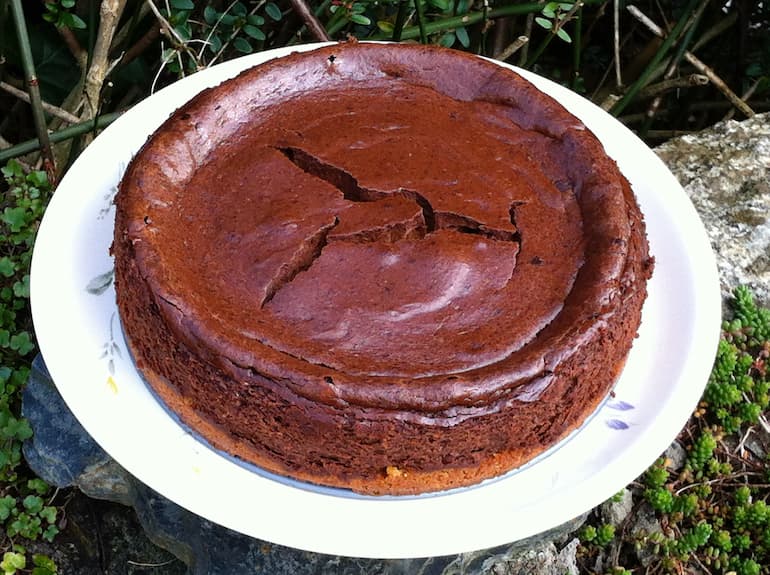 A whole baked chocolate cheesecake with a gluten-free marzipan base.