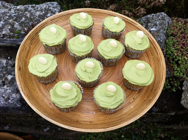 Matcha Cupcakes with White Chocolate on a bamboo tray.