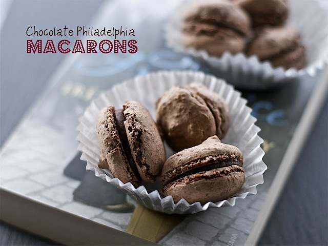 Homemade chocolate Philadelphia macarons in paper cases.