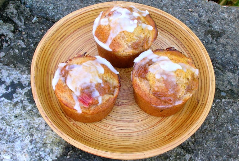 Three rhubarb nonnettes with a little icing drizzled over the tip.
