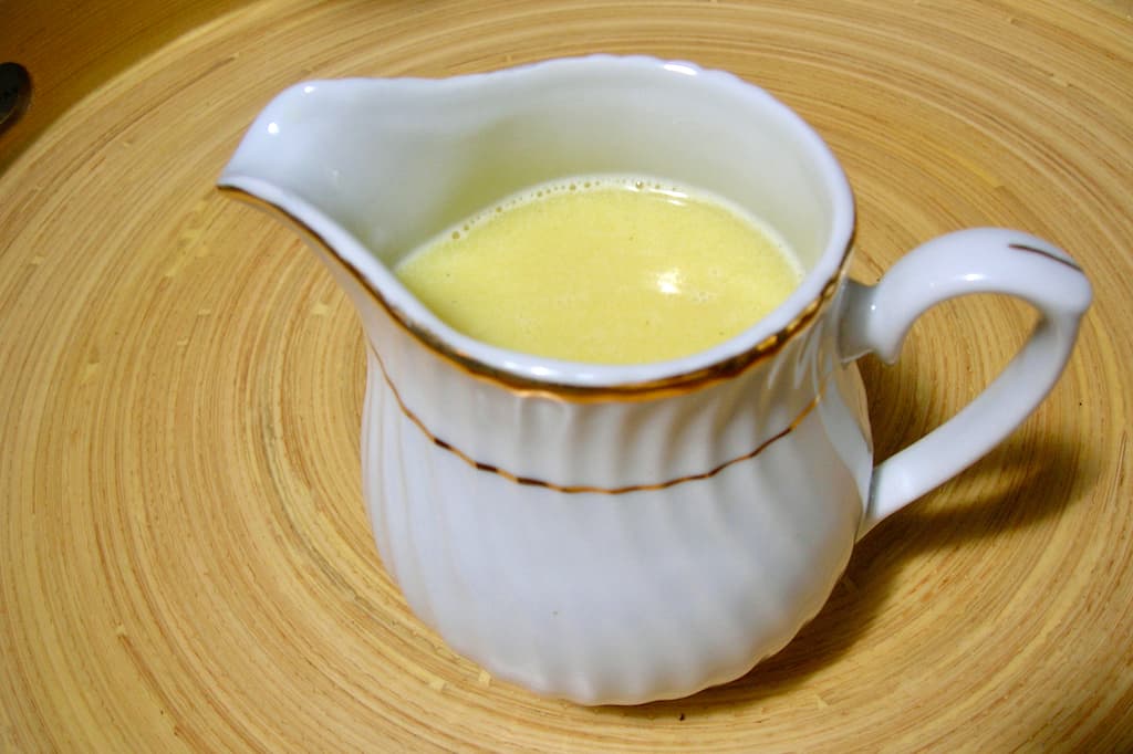 A jug of white chocolate sauce.