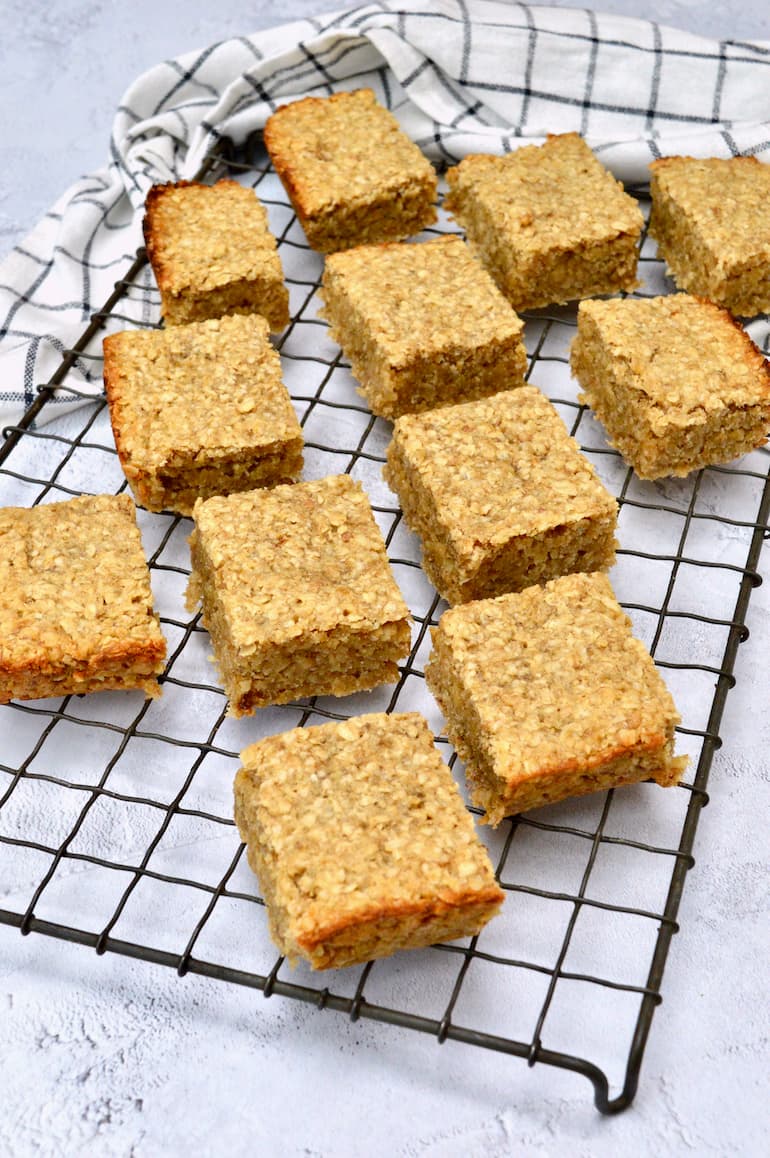 Homemade banana coconut flapjacks cooling on a wire rack.