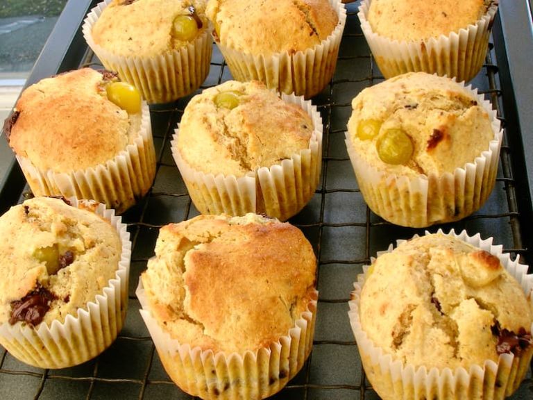 Choc chip and ground cherry breakfast muffins cooling on a rack.
