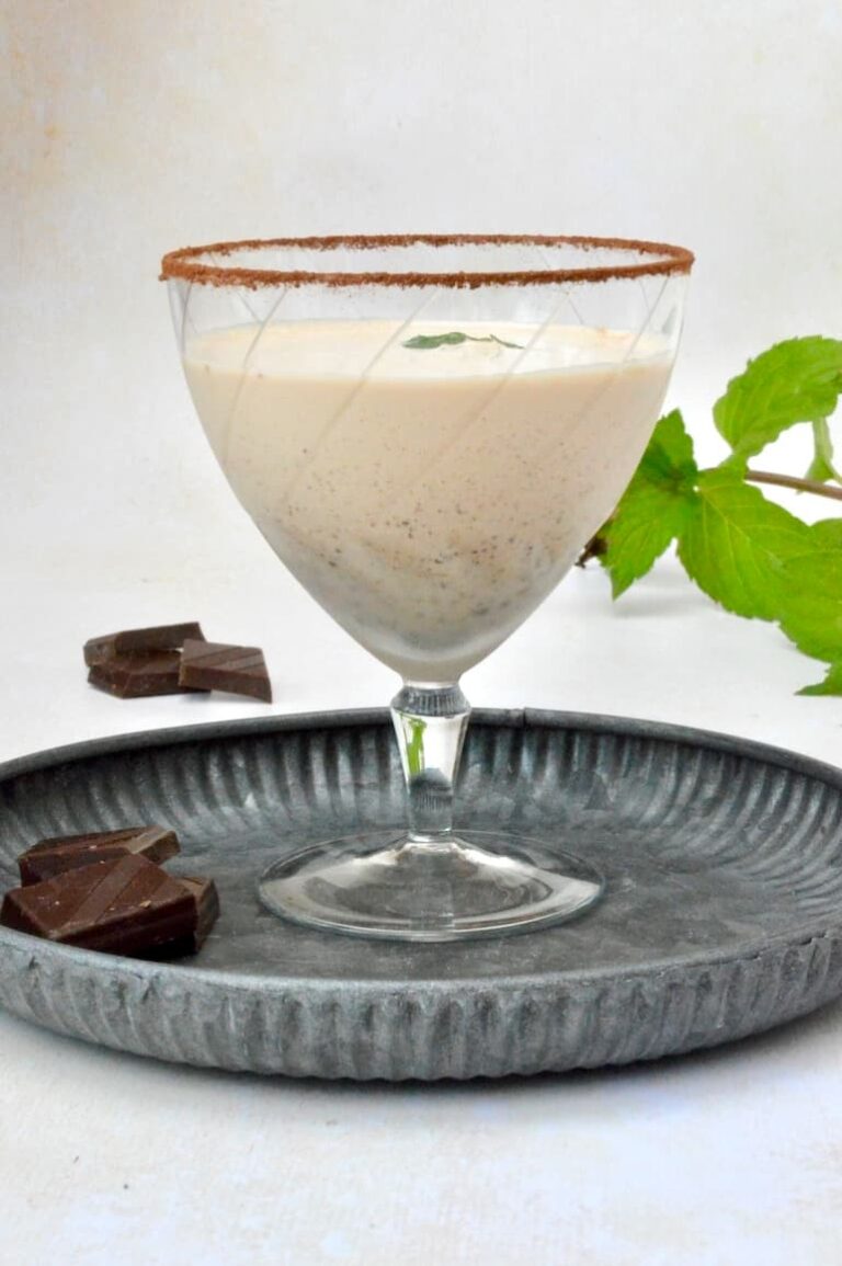 Cool and creamy chocolate mint cocktail in glass with sugar and cocoa dusted rim.