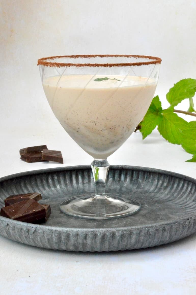 Cool and creamy chocolate mint cocktail in glass with sugar and cocoa dusted rim.