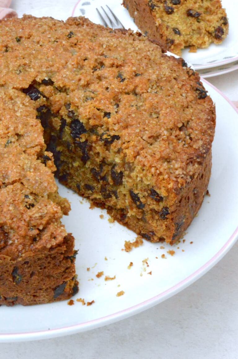 Egg-free vinegar cake on stand with slice removed.