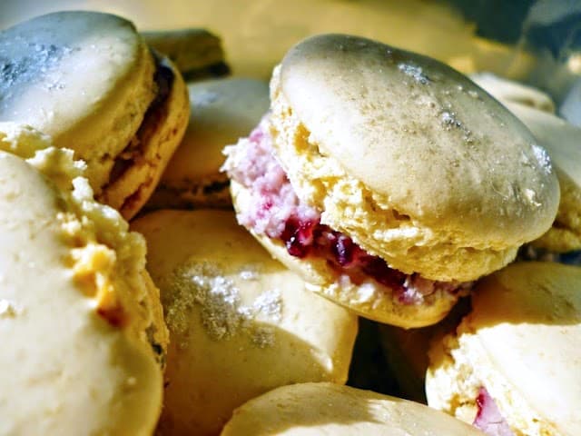 A pie of macarons sandwiched with blackcurrant jam.