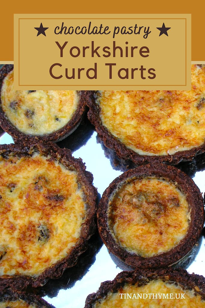 Pin showing close up of homemade Yorkshire curd tarts with chocolate pastry.