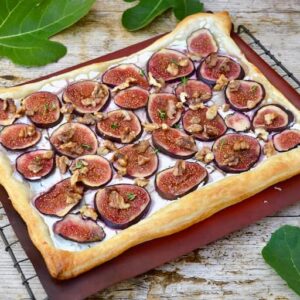 Fig, walnut, honey and thyme goat's cheese puff pastry tart cooling on a wire rack.