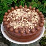 A Malteser cake decorated with whole and crushed Maltesers.